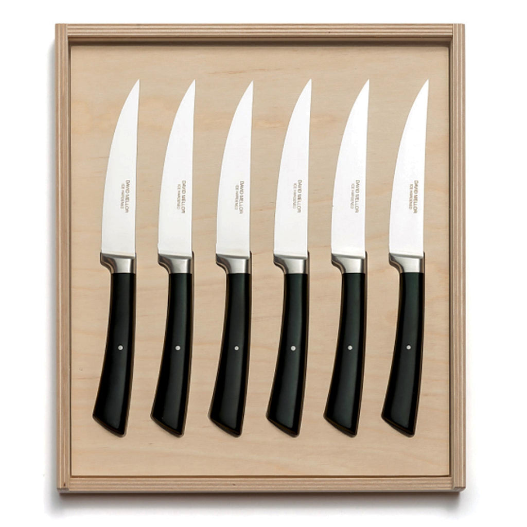David Mellor black handle steak knife set. PRODUCT CODE 2518050. Black handled steak knives are made from high carbon stainless steel. The latest techniques in casting and precision grinding are used in conjunction with ice hardening to produce an extremely sharp and durable blade. The acetal resin handle incorporates an internal back weight, giving an excellent balance and grip. Steak knife blades are micro-serrated for effortless cutting.
