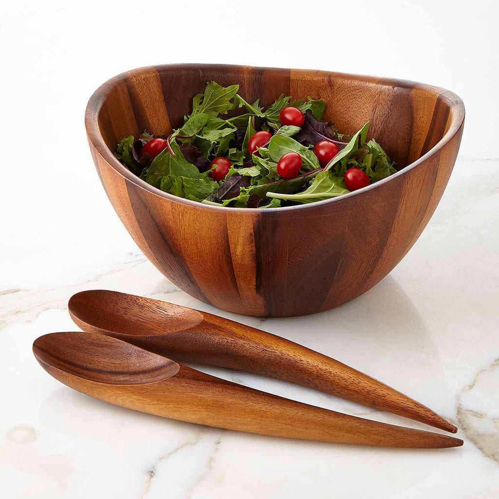 Elegant lines and flowing curves done in rich, gorgeous acacia wood make the Harmony Salad Set an instant classic. The generously rounded bowl paired with the unique shape of the tongs make it easy to toss and arrange your healthy creations. 