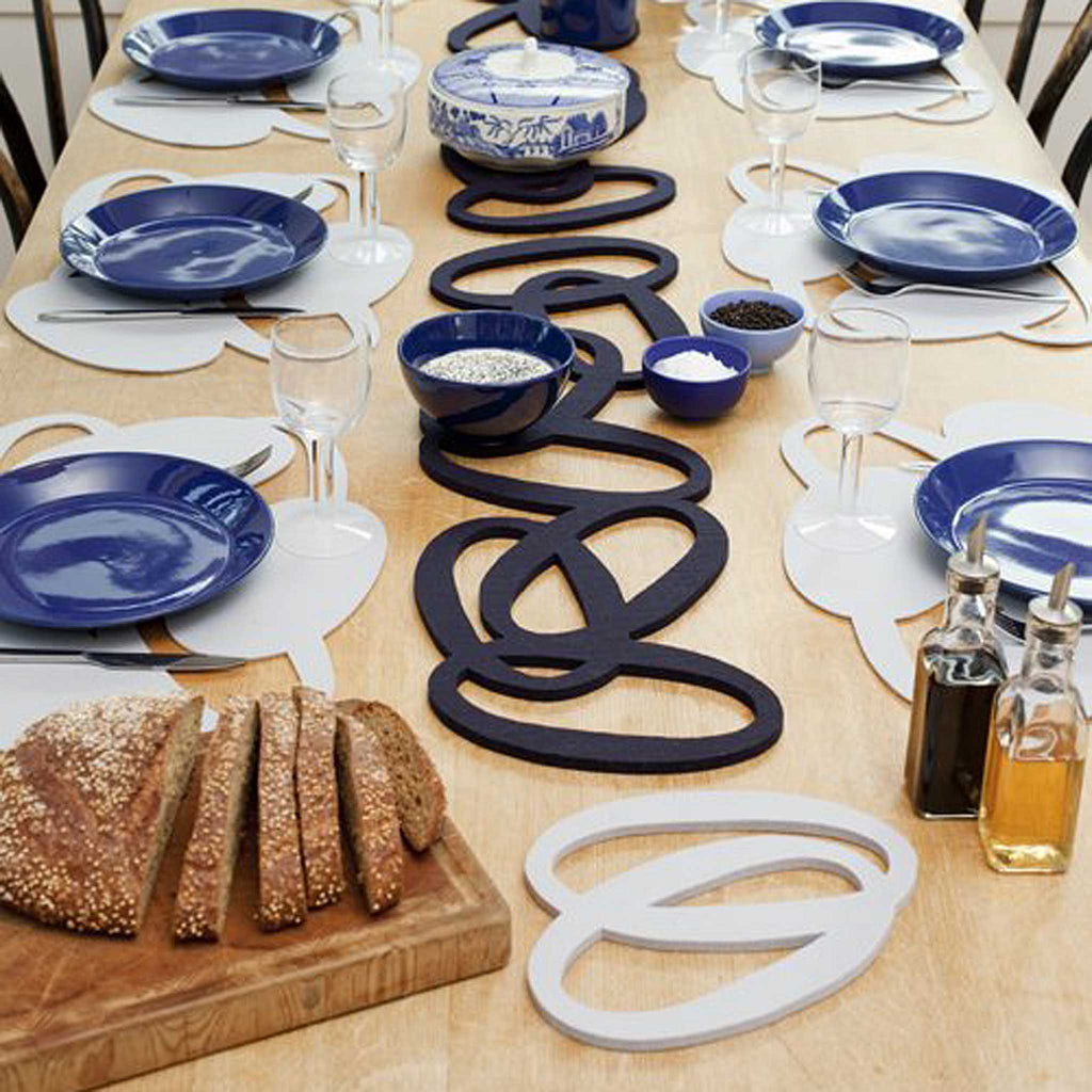 The long Silmu Trivet is a Verso Design classic and still one of the most popular trivets. These trivets and table runners are from Verso Design, a Finnish design house that specializes in modern textiles and innovative home accessories inspired by nature. The design features overlapping ovals from laser-cut from thick, felted wool.