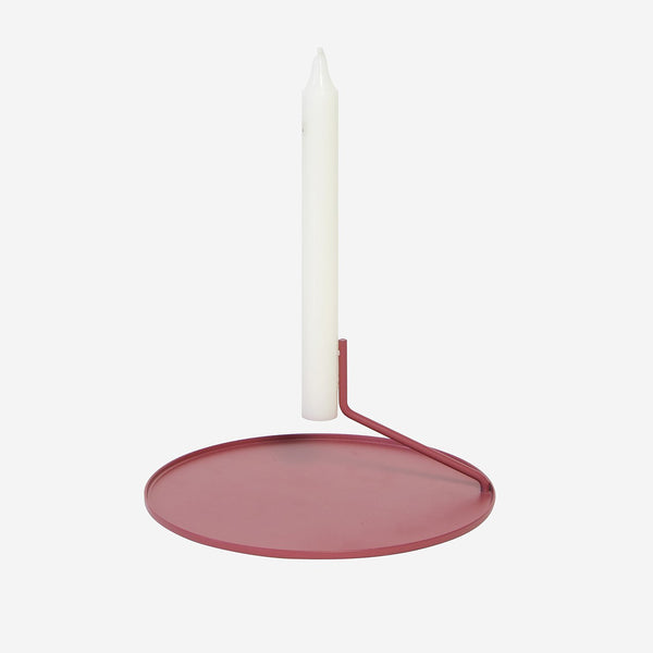 Buka Candlestick by Diiis for Souda. aBUKA1002s (brick red). Simple, elegant, and mysterious, the Buka Candlestick uses two pins to suspend a candle above a metal dish - giving it the appearance that it's levitating. Minimal, yet visually effortless, this candleholder is exactly what you need to create a warm, weightless mood. 