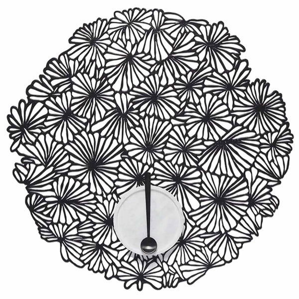Daisy Round Placemat in black. SKU 100716-001. UPC 667880942150.Taking the playful form of a tightly clustered bouquet of daisies as viewed from above, this flexible openwork placemat acts as a decorative base for whatever is placed on top. It is delicate in appearance yet surprisingly resilient: a contemporary interpretation of both classic florals and the ancient craft of lacemaking. 