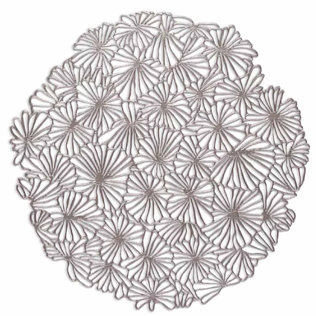 Chilewich Daisy Round Placemats in gunmetal. SKU 100716-003. UPC 667880942174. It is delicate in appearance yet surprisingly resilient: a contemporary interpretation of both classic florals and the ancient craft of lacemaking. 