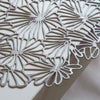 Daisy Round Placemat in gunmetal. SKU 100716-003. UPC 667880942174. Pressed Daisy ©2022 Chilewich. It is delicate in appearance yet surprisingly resilient: a contemporary interpretation of both classic florals and the ancient craft of lacemaking. 
