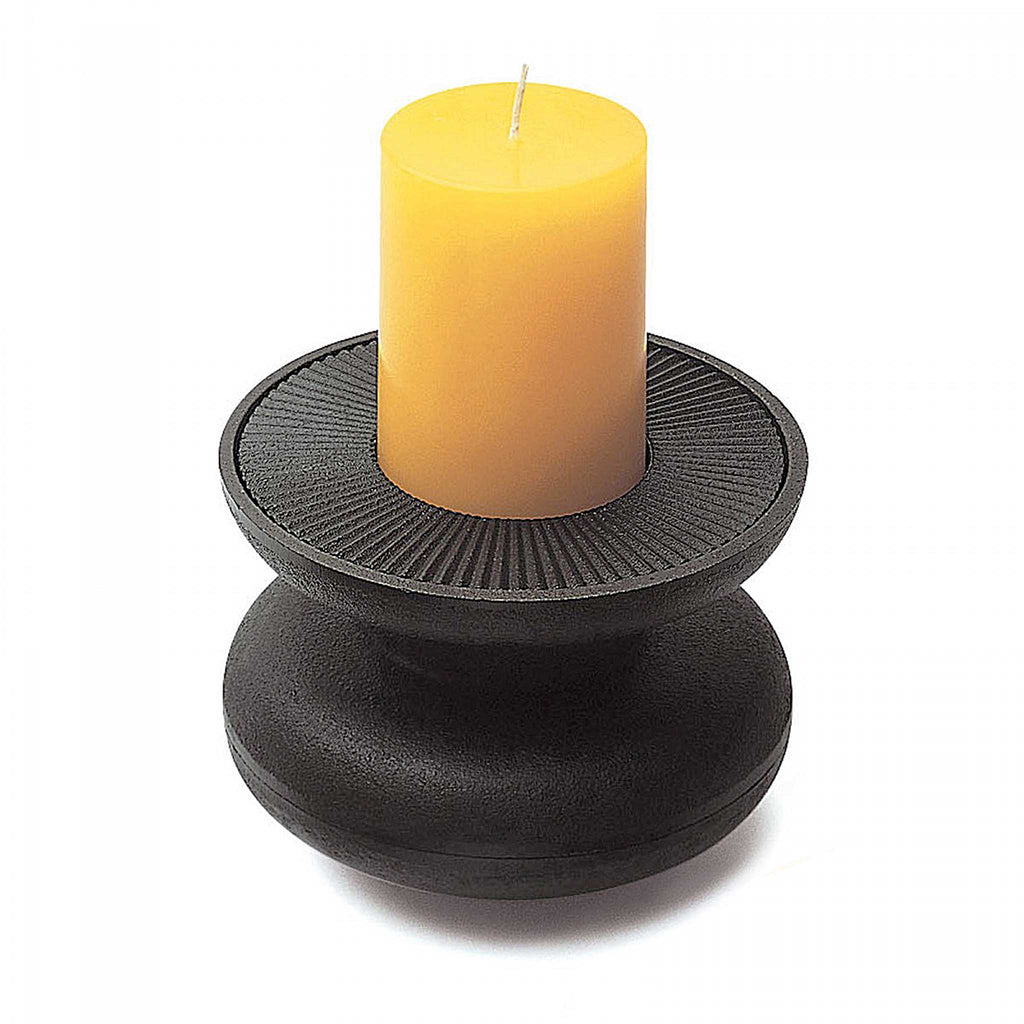 David Mellor tall cast iron candleholder. 4741022. David Mellor's cast iron candleholders were originally designed in 1969, the year when our shop in Sloane Square first opened. We recently located an iron foundry with the traditional skills to make these now classic Swinging Sixties design. The matte black bowls have ridged inserts.