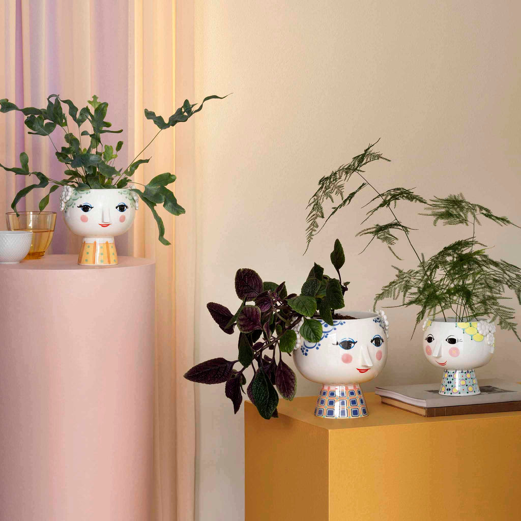 Bjørn Wiinblad Eva Flowerpot 56512. This version of Bjørn Wiinblad's famous plant pot depicts Eve, on a beautifully decorated base. It will add a touch of retro cool to your home with its elegant neck and the charming female face motif. 