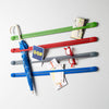 Droog Strap Collection. Phones, keys, books, remote controls, toys and other objects that always get lost, can be stored as decoration behind these colourful elastic belts.