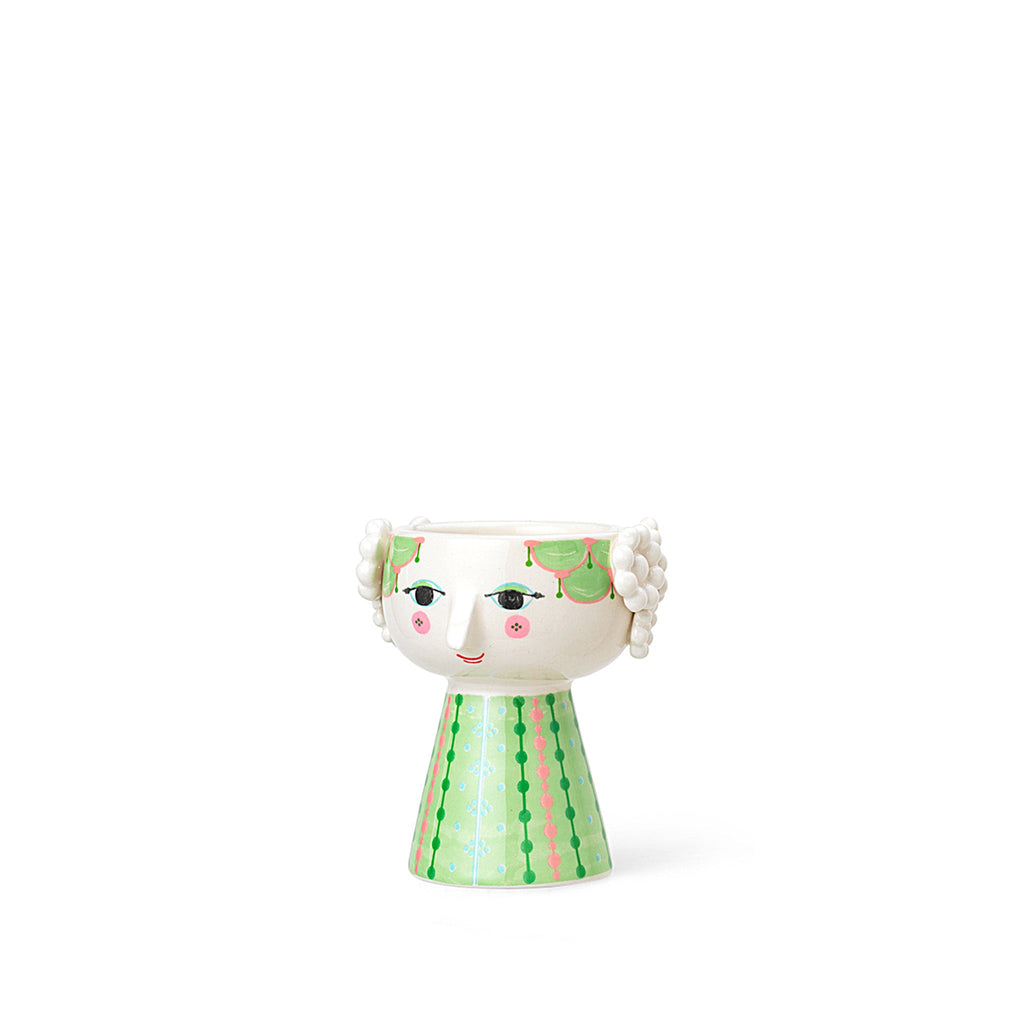 Bjørn Wiinblad Eva Candle Holder, Light Green 54044. Meet spring with delicate, bright green shades and whimsical patterns. The red-cheeked candlestick is a reinterpretation of Wiinblad's original candlestick, Eva. Eva is characterized by the broad head and a cone-shaped stage shape. The friendly face is made according to Wiinblad's own line.